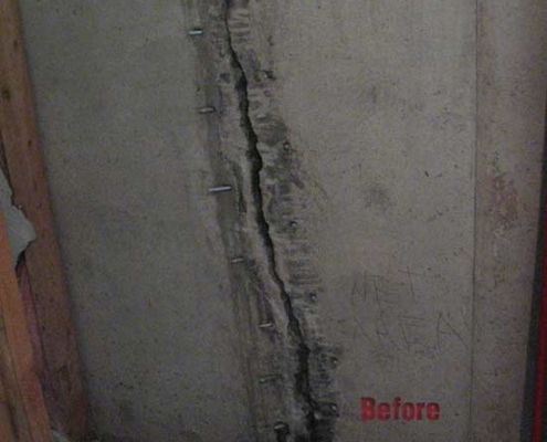 A cracked concrete wall with visible bolts along the crack, illustrating damage before polyurethane grout injection repair. The word "Before" is written in red at the bottom right of the wall.