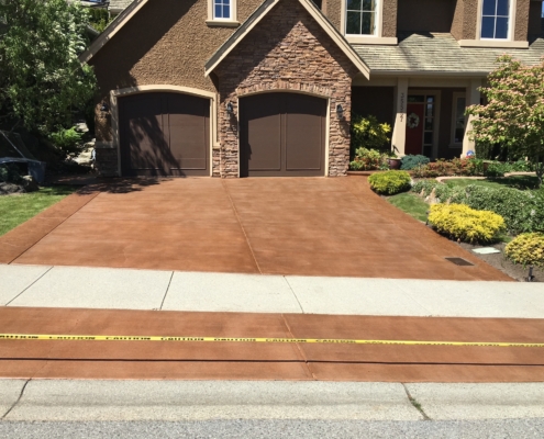 stained brown concrete driveway after resurfacing