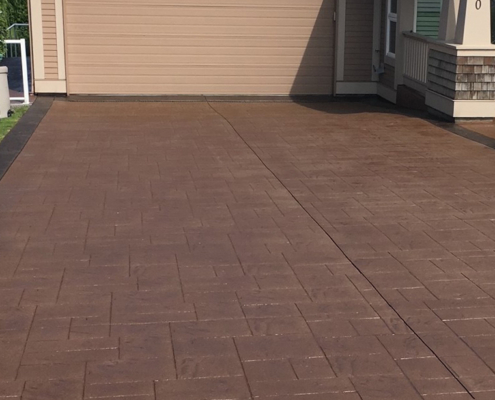 stamped brown concrete driveway after sealing