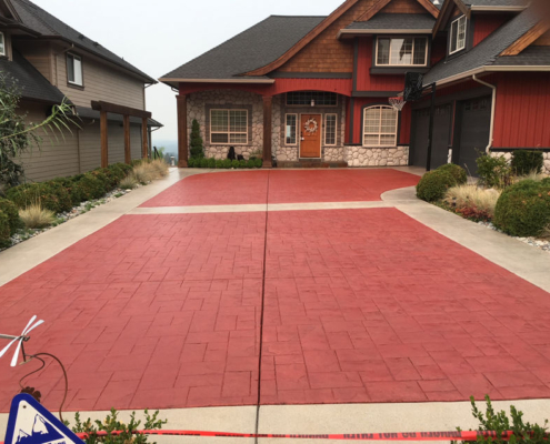 stamped red concrete driveway after sealing