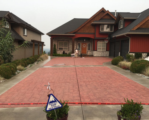 stamped red concrete driveway before sealing