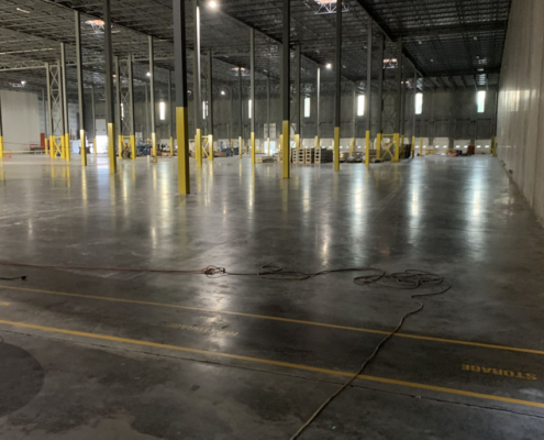 IMG_2572 warehouse concrete floor needing repair yellow pillars