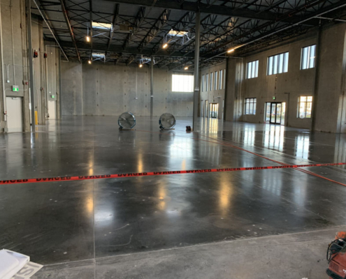 IMG_1573 warehouse polished concrete floor fans warning tape